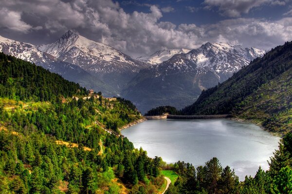 Mountain lake among the greenery of trees