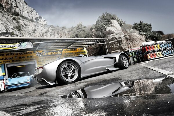 Auto repair shop, supercar, reflection on asphalt