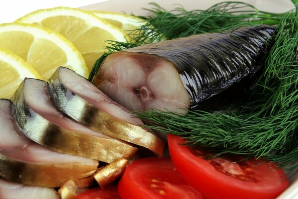 Classic smoked mackerel appetizer with lemon, herbs and tomatoes