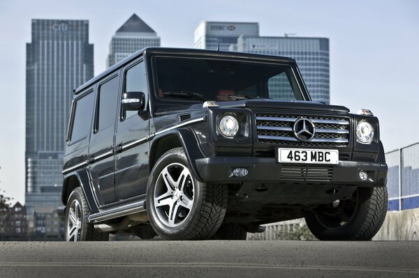 Black Mercedes car on the background of multi-storey buildings