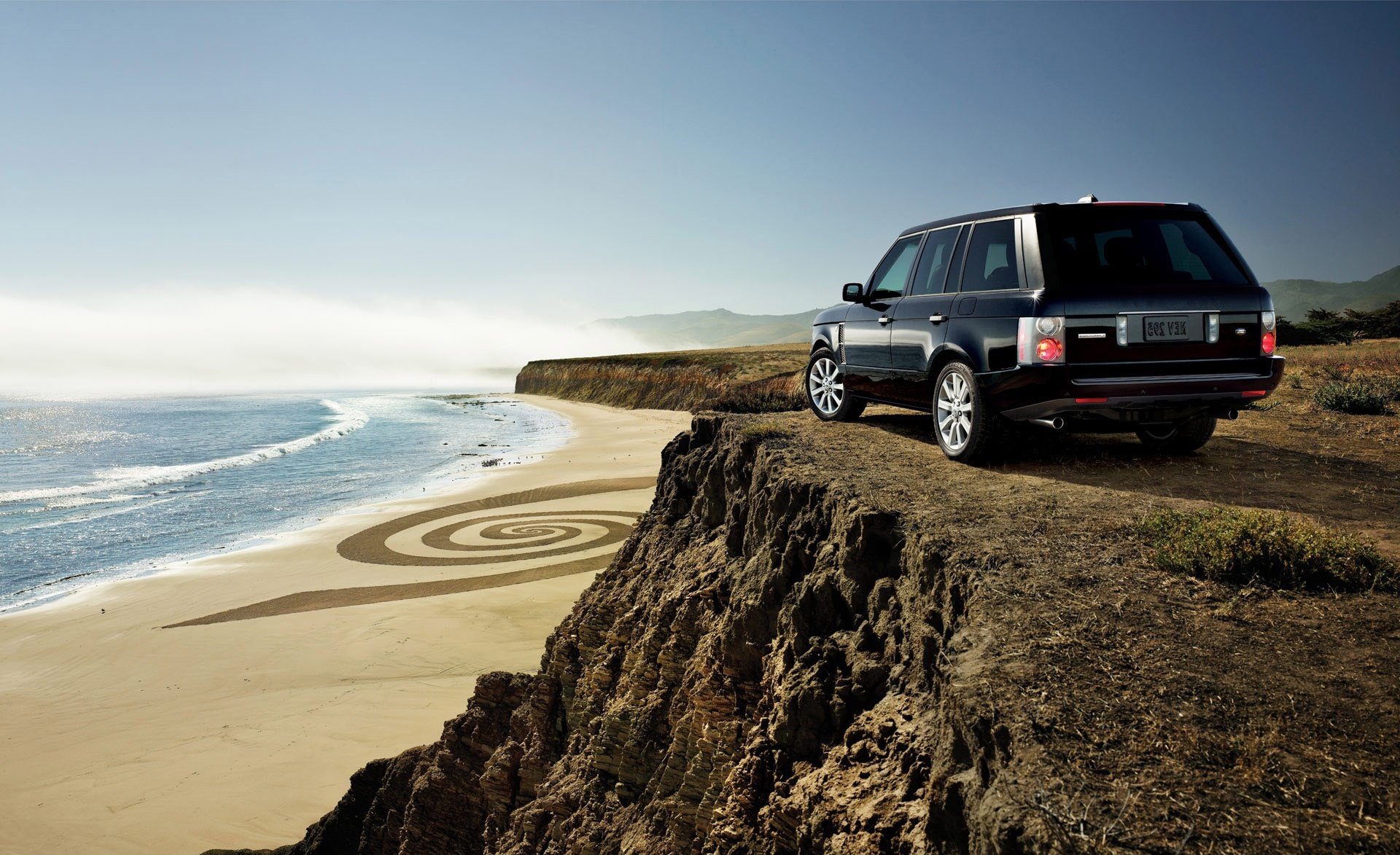 range rover cars rocks beach sand wheelbarrows cars cars with cars sky rocks sea ocean water jeep height shore gra