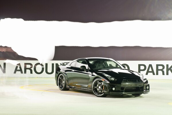 A picture of a nissan gt-r car skidding