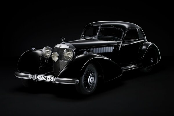 Outline of a retromobile on a black background