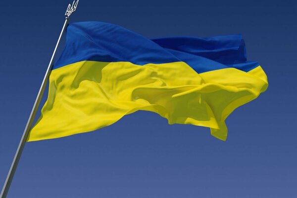 The Ukrainian flag is flying against the sky