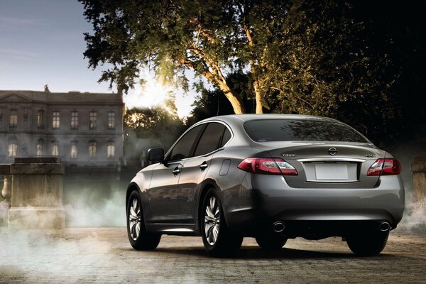 Gray Nissan car amid the smoke