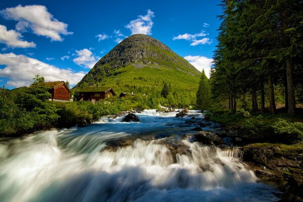 Mountain waterfall near the houses