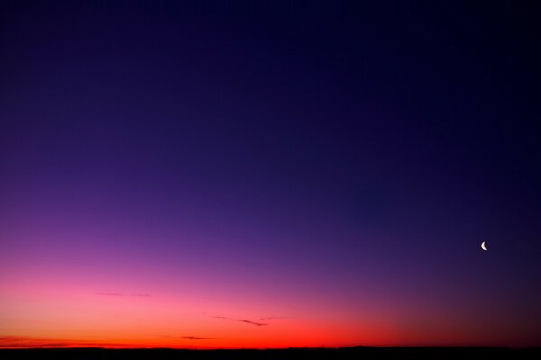 The moon on the background of a beautiful sunset