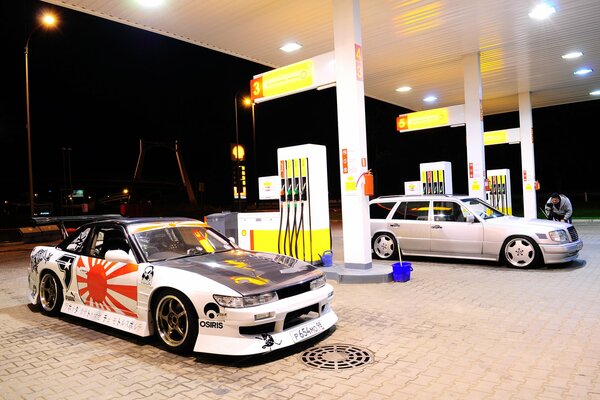 Nissan and Mercedes at the gas station