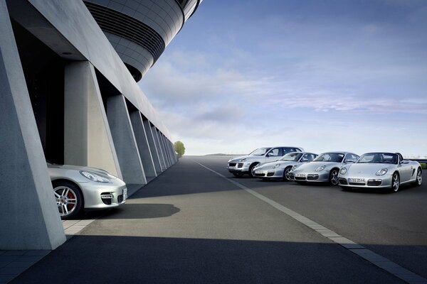 A line of silver Porsches near the garage