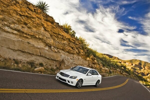 White Mercedes speeding through the desert