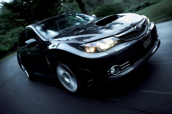 Country road. A black car in motion