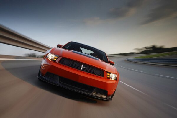 The beautiful red mustang is picking up speed