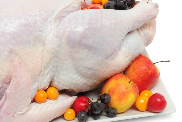 Chicken with berries and fruits on a white background