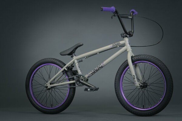 Grau mit lila Griffen bmx Fahrrad auf grauem Hintergrund