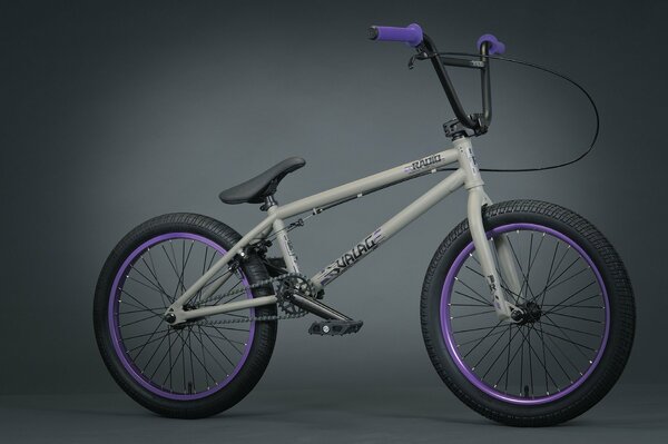 Grey with purple handles bmx bike on grey background