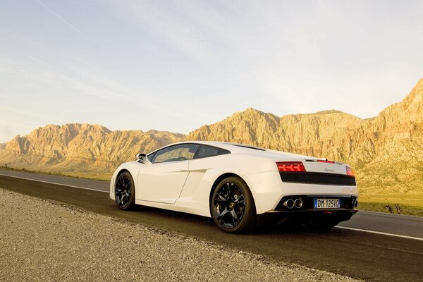 Coche Lamborghini en la pista entre las montañas