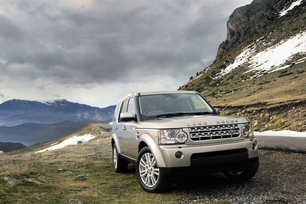 Land rover car on the background of grass and clouds