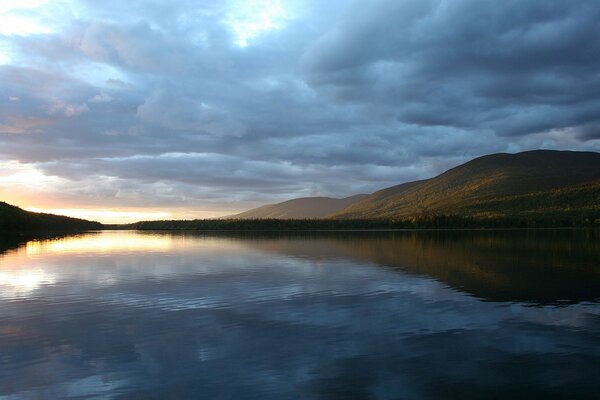 The river reflects the mountain and the sky