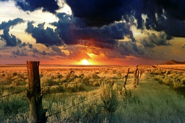 Homemade fence on the background of sunset