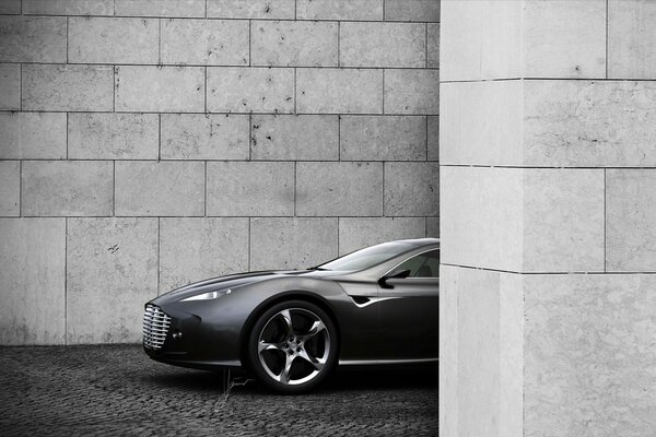 Aston Martin hiding behind a wall