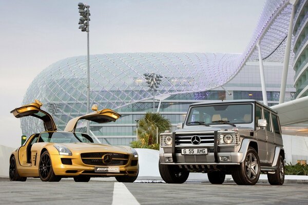 Golden Mercedes with open doors on the background of the building 