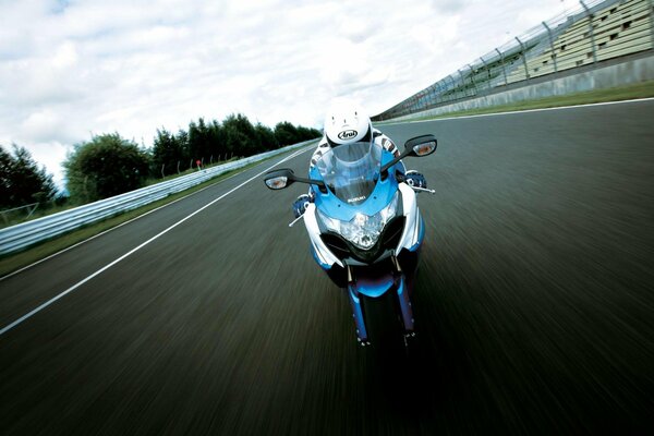 A motorcyclist on a motorcycle is driving along the road