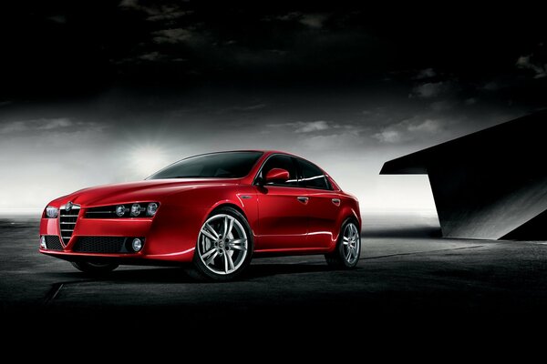 A red car on a dark background looks wonderful