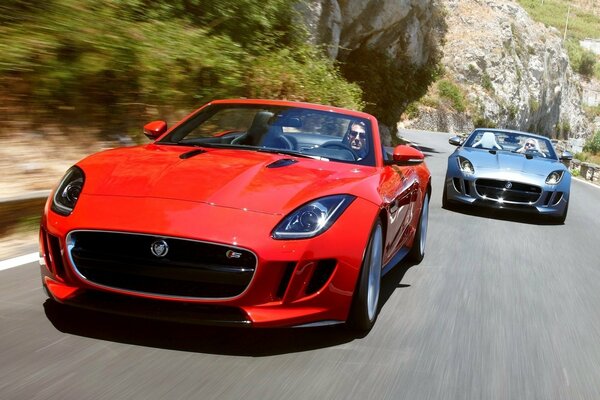 Two supercars at speed on the road