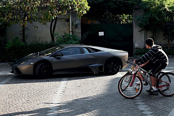 Stylish image of a lamborghini and a bicycle