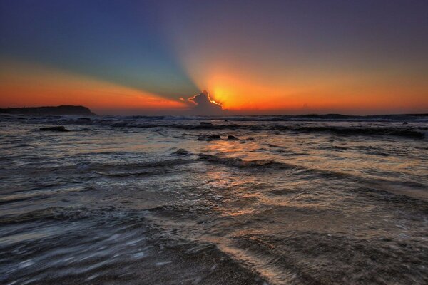 Tramonto luminoso dalle nuvole nel mare