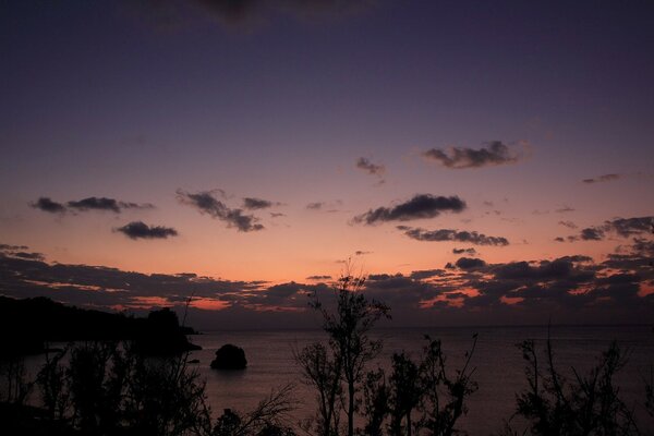 Romantic sunset with a fan in the sea in the clouds