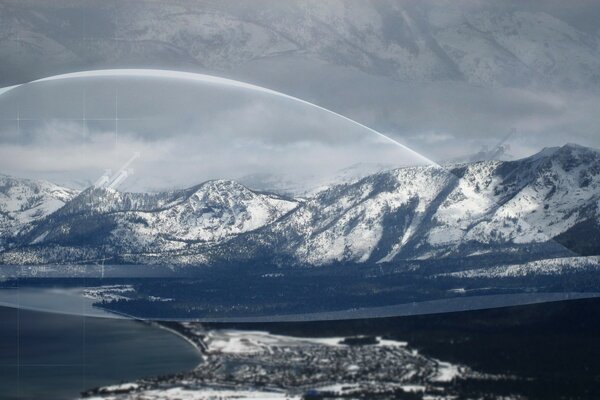 Processed image of snow-capped mountains against a gray sky background