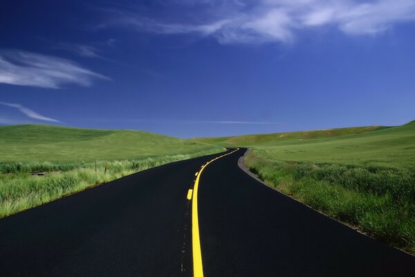 The new asphalt road goes into the horizon