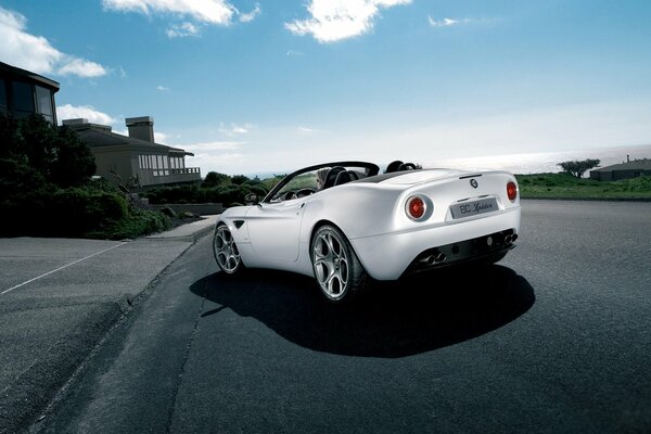 A white Alfa Romeo parked at the curb