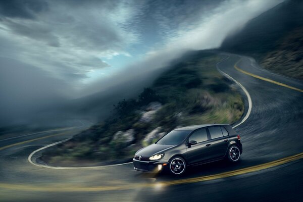 Black Volkswagen on a mountain serpentine