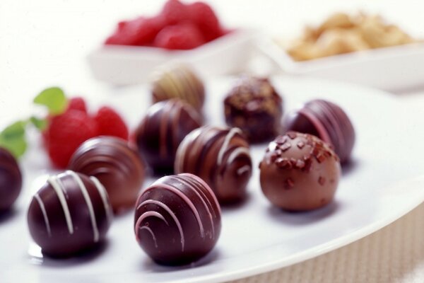 Round chocolate candies in glaze