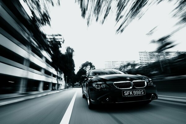 Black and white car in motion on the road