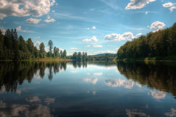 Clouds are reflected in the forest lake