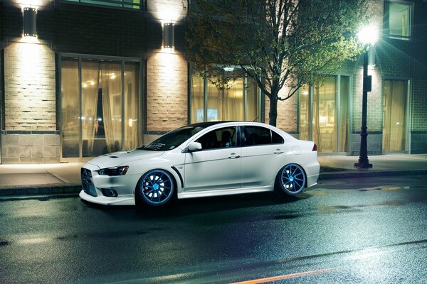 White Mitsubishi Lancer on the evening street