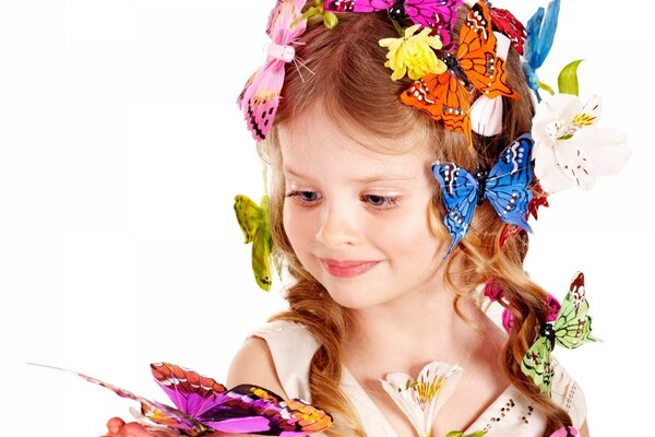 A girl with a flower holds a butterfly in her hand