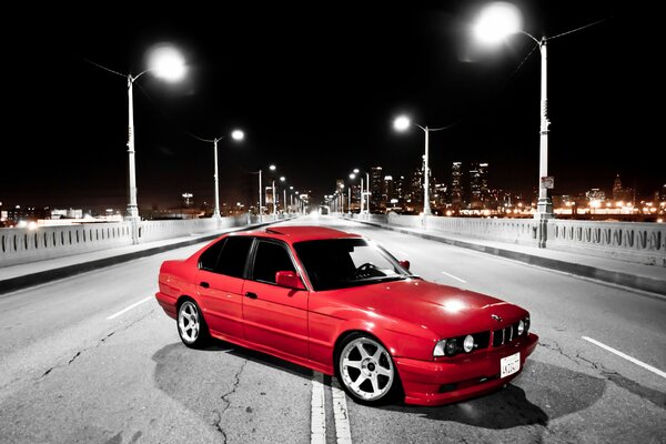 Red BMW in black and white photo of the bridge