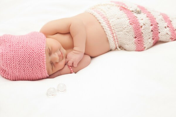 A child in a pink uniform is sleeping