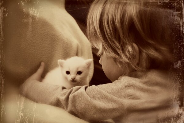 The child surrounded the kitten with care