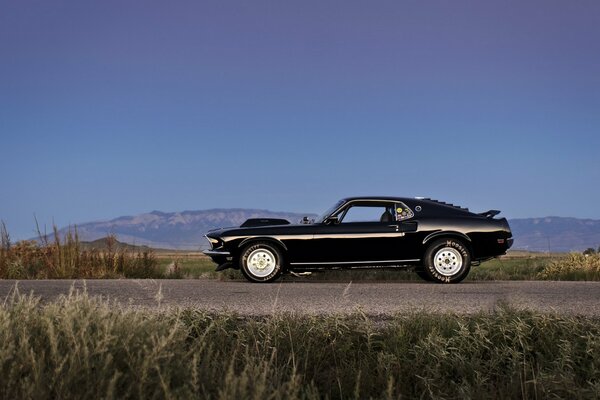 Schwarzer ford mustang fährt auf der Straße