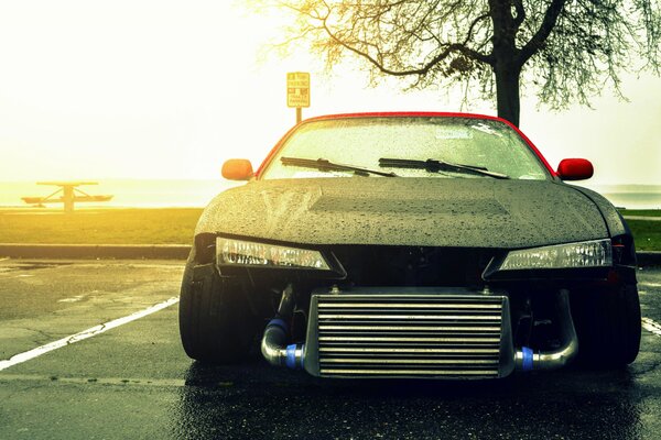 Nissan Silvia bajo la lluvia al atardecer