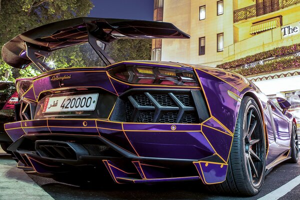 Bright purple lamborghini supercar in the parking lot