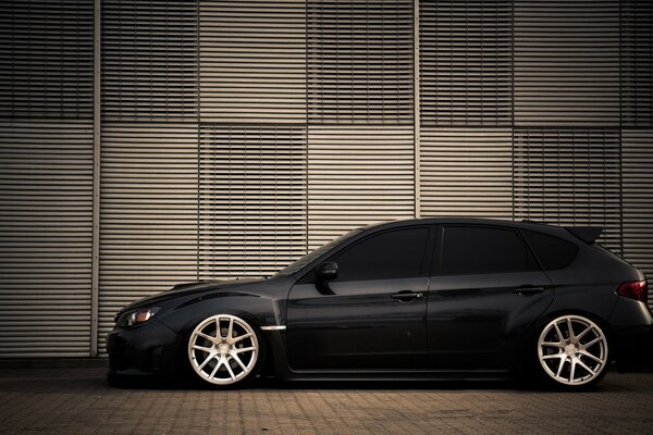 Black subaru impreza in profile