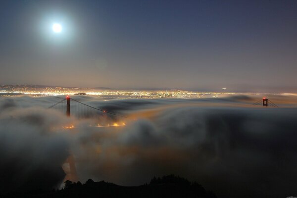 Night fog over the city in the light of the moon