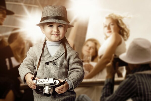 Niño con sombrero y cámara en la mano