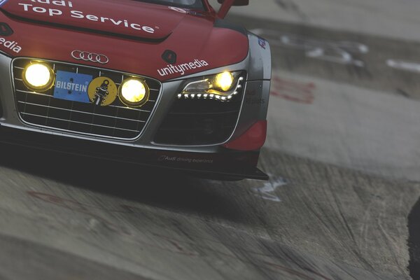 Red Audi in a race on the track